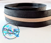 Rose gold with black number 5 zipper tape