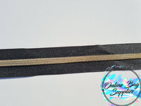Gold with black zipper tape